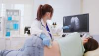 doctor showing a patient her kidneys in an ultrasound exam